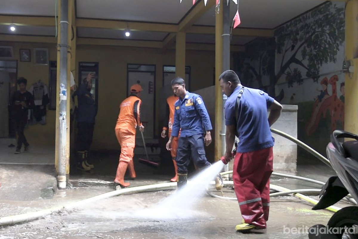 Personel Gabungan Bersihkan Sampah dan Lumpur Sisa Genangan di Kampung Melayu 