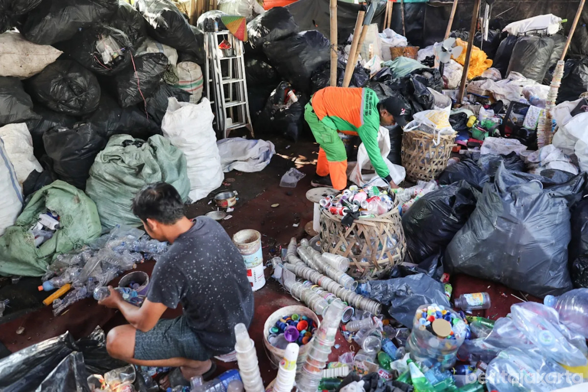Petugas dan warga melakukan pemilahan sampah anorganik