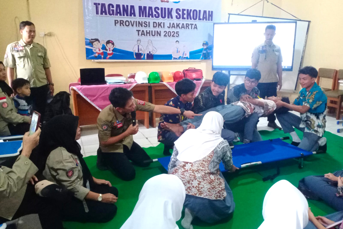 Petugas memandu sejumlah siswa cara mengevakuasi korban menggunakan tandu