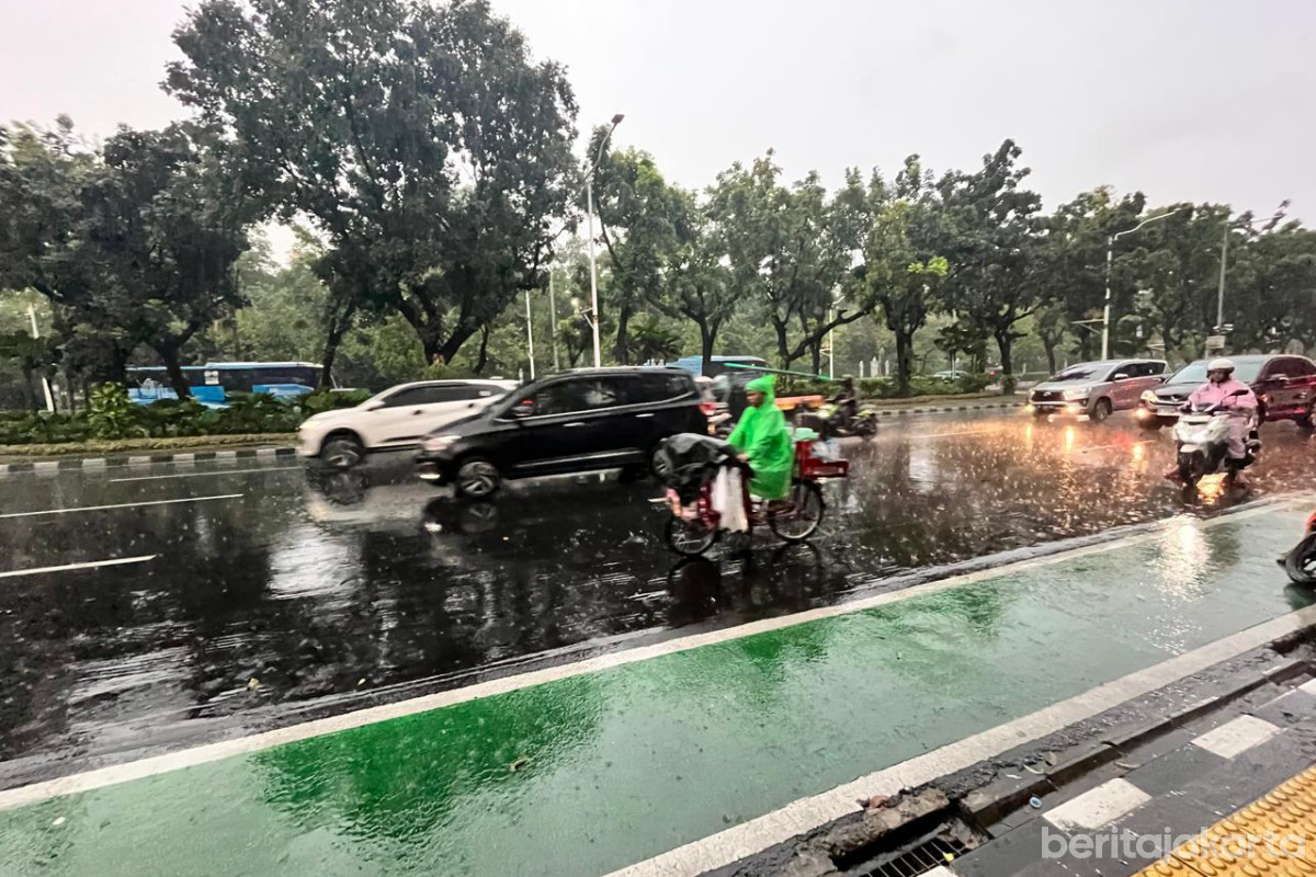 Sejumlah kendaraan melintas di jalan saat cuaca hujan