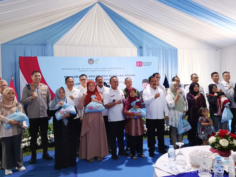 Warga menerima sembako usai menjalani pemeriksaan kesehatan